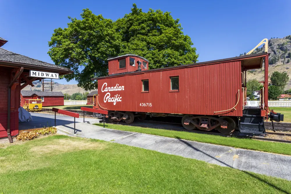 old red canadian caboose stationary on tracks