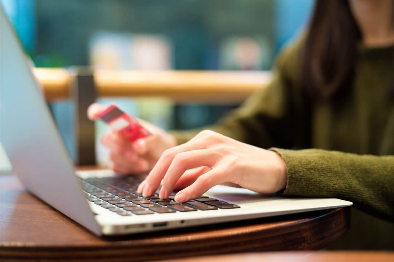 woman shopping online with amtrak points