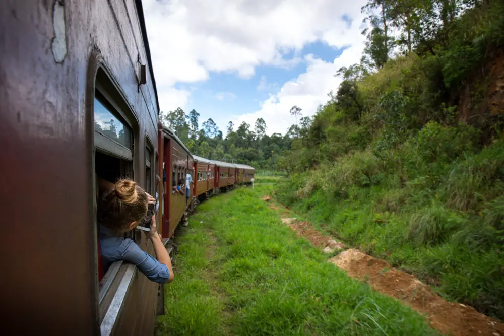 woman taking picture on train ride